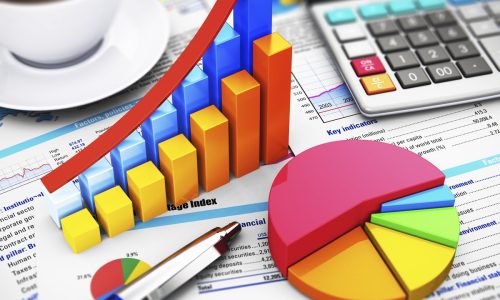 Business finance, tax, accounting, statistics and analytic research concept: macro view of office electronic calculator, bar graph charts, pie diagram and ballpoint pen on financial reports with colorful data with selective focus effect
